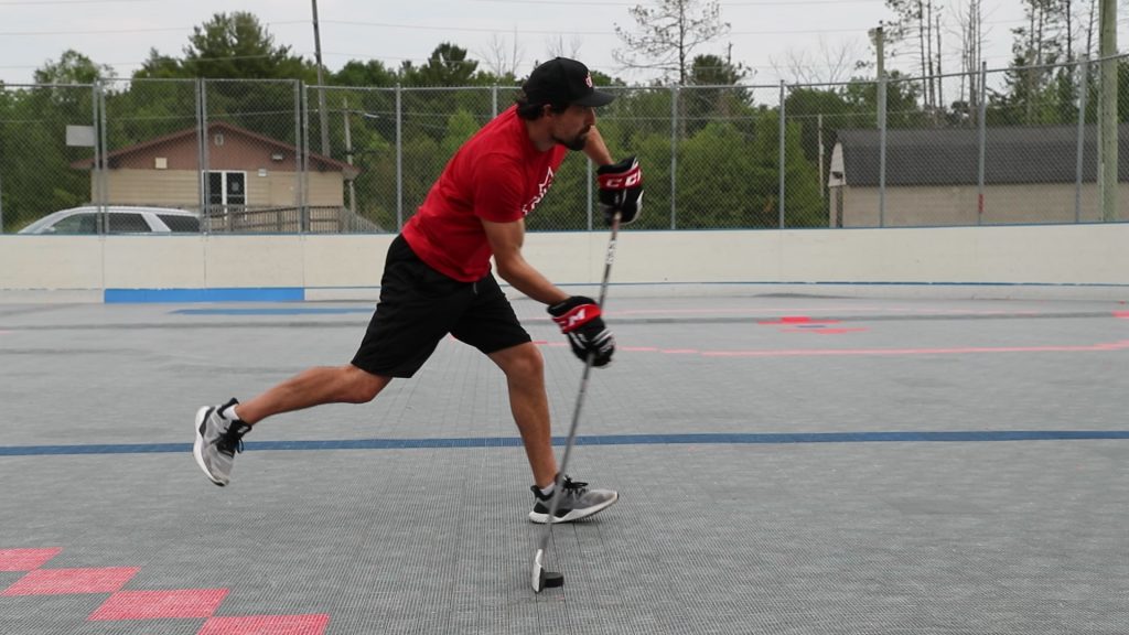 Coach Jeremy demonstrating the timing of a wrist shot release