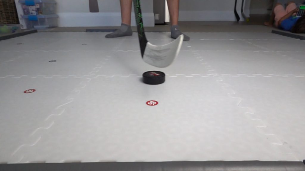 A close-up of puck control on a hockey stick blade