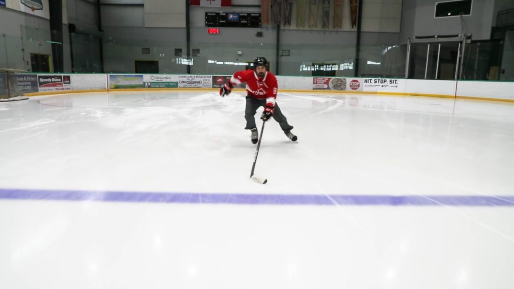 Coach Jeremy demonstrating the forward stride on the ice